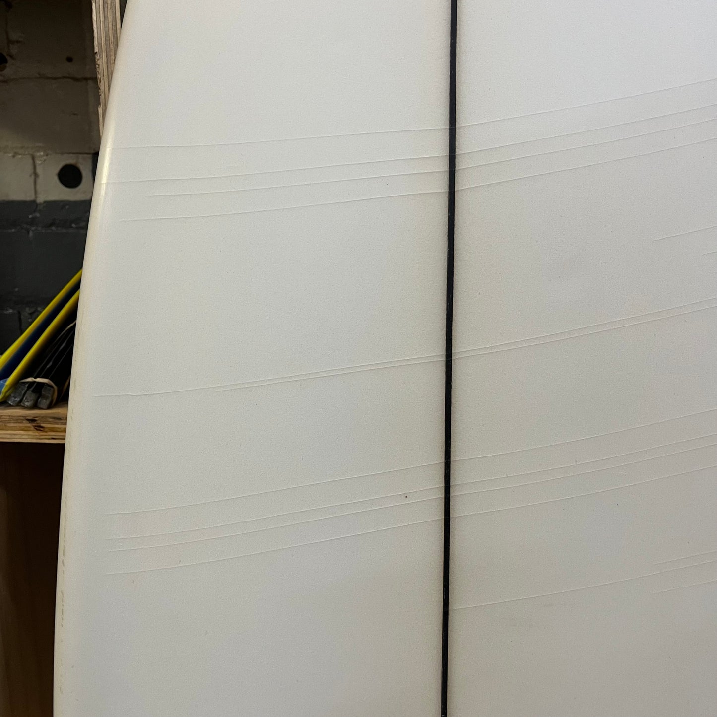 ACSOD White Ferrari 5'11" secondhand surfboard showing subtle stress fractures on bottom