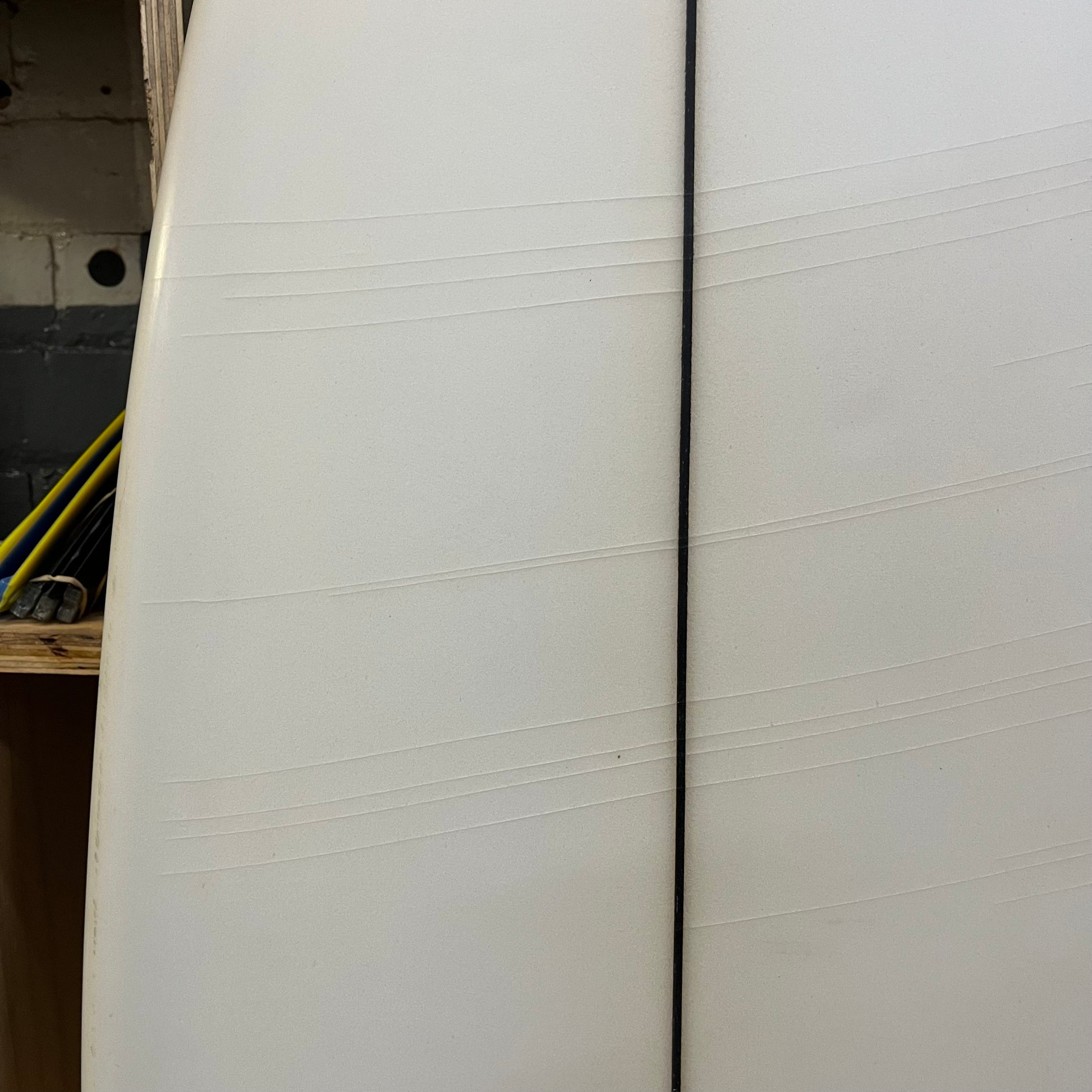 ACSOD White Ferrari 5'11" secondhand surfboard showing subtle stress fractures on bottom