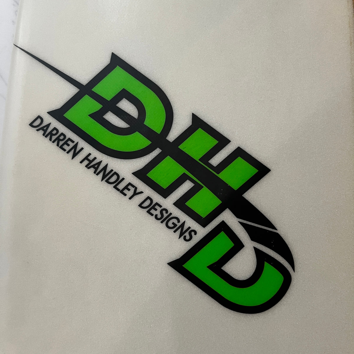 DHD Monster 6'10" secondhand surfboard brand logo close-up