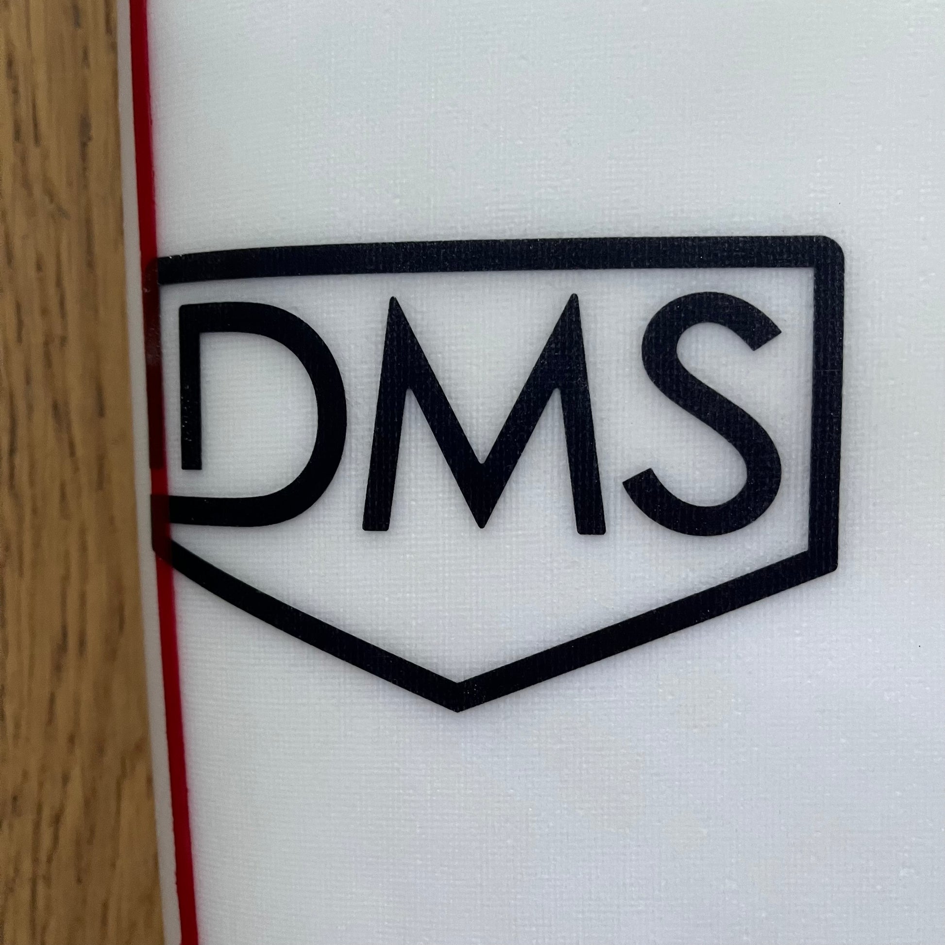 DMS Fish 5'8" secondhand surfboard brand logo close-up