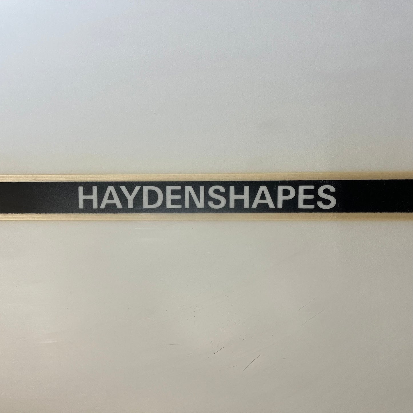 Hayden Shapes mid length glider 8'7" secondhand surfboard brand name close-up