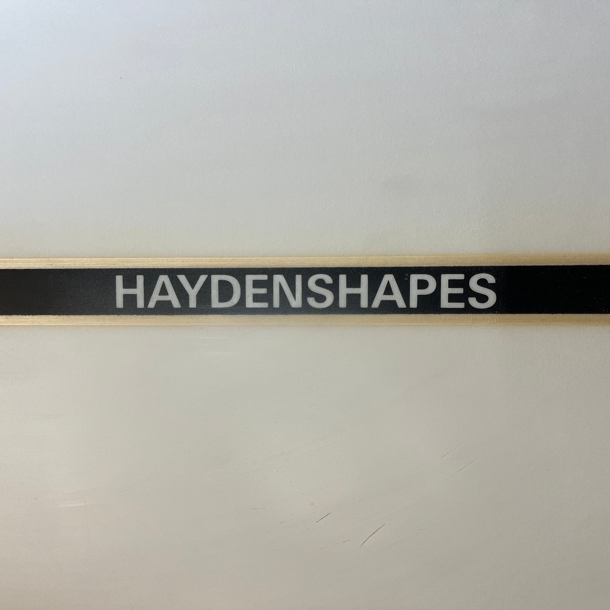 Hayden Shapes mid length glider 8'7" secondhand surfboard brand name close-up