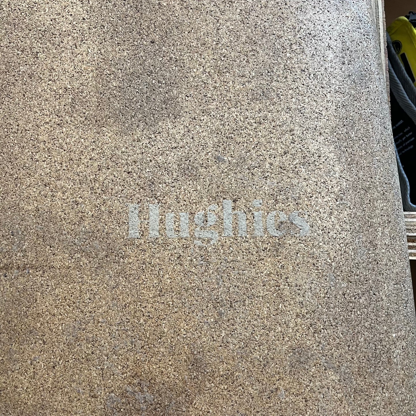 Hughies cork mid-length 7'11" secondhand surfboard brand logo close-up